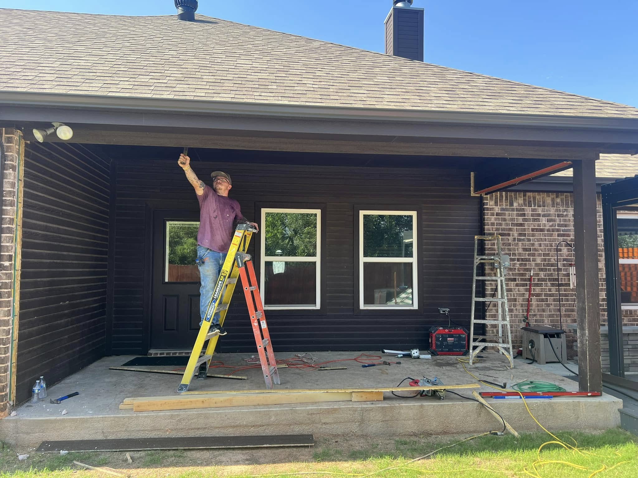 Exterior renovation work underway on a covered patio